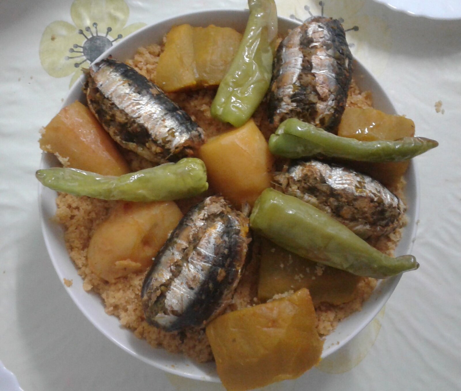 Sarde fritte con cipolle, uvetta e pinoli in un piatto da portata
